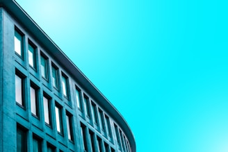 Modern minimalist architectural building with clean black and cyan lines.