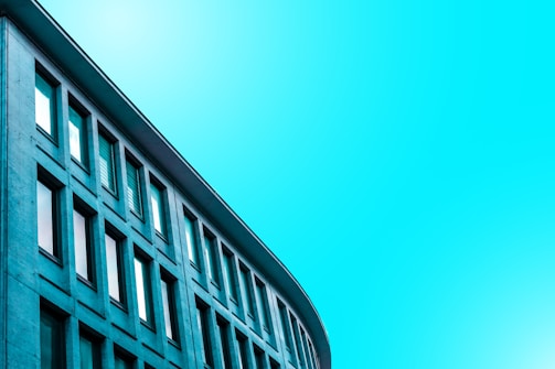 Modern minimalist architectural building with clean black and cyan lines.