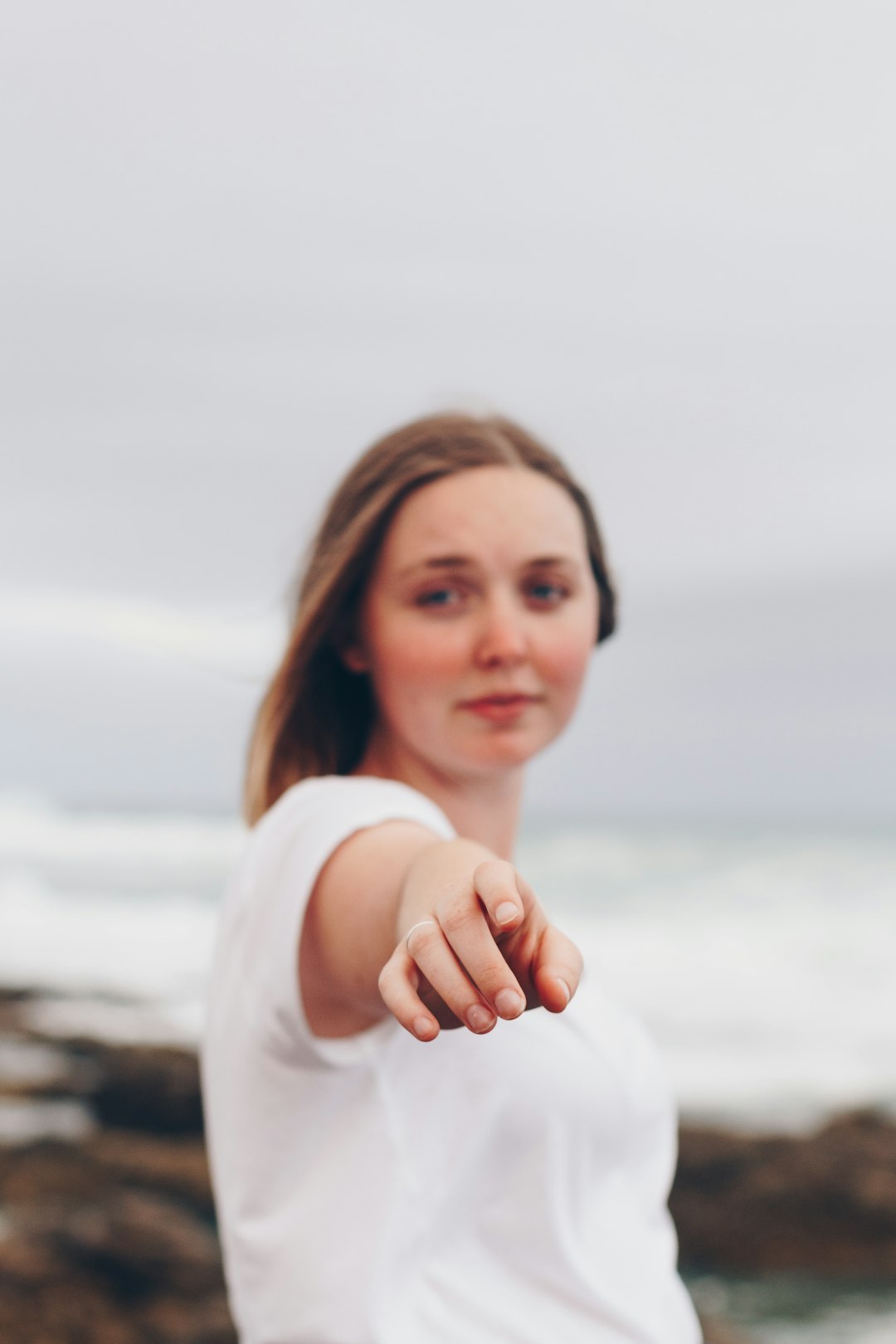 woman in white shirt pointing