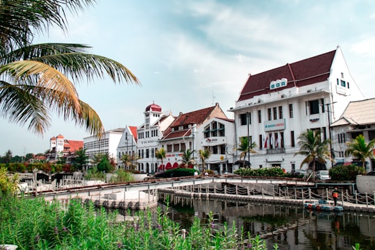 white concrete houses near river in Fatahillah Square Indonesia