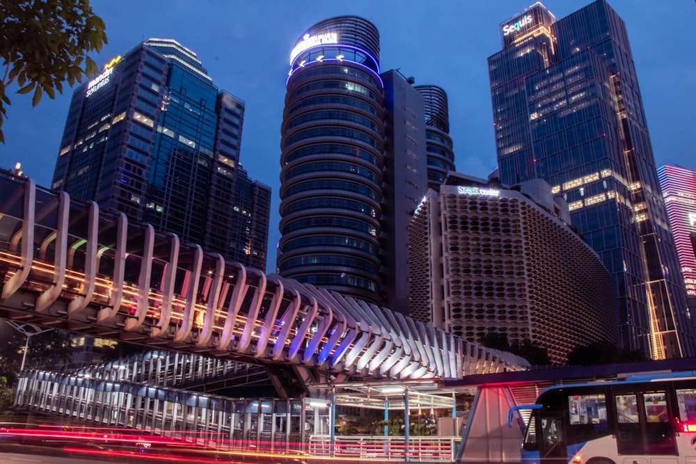 gray concrete bridge near high-rise buildings