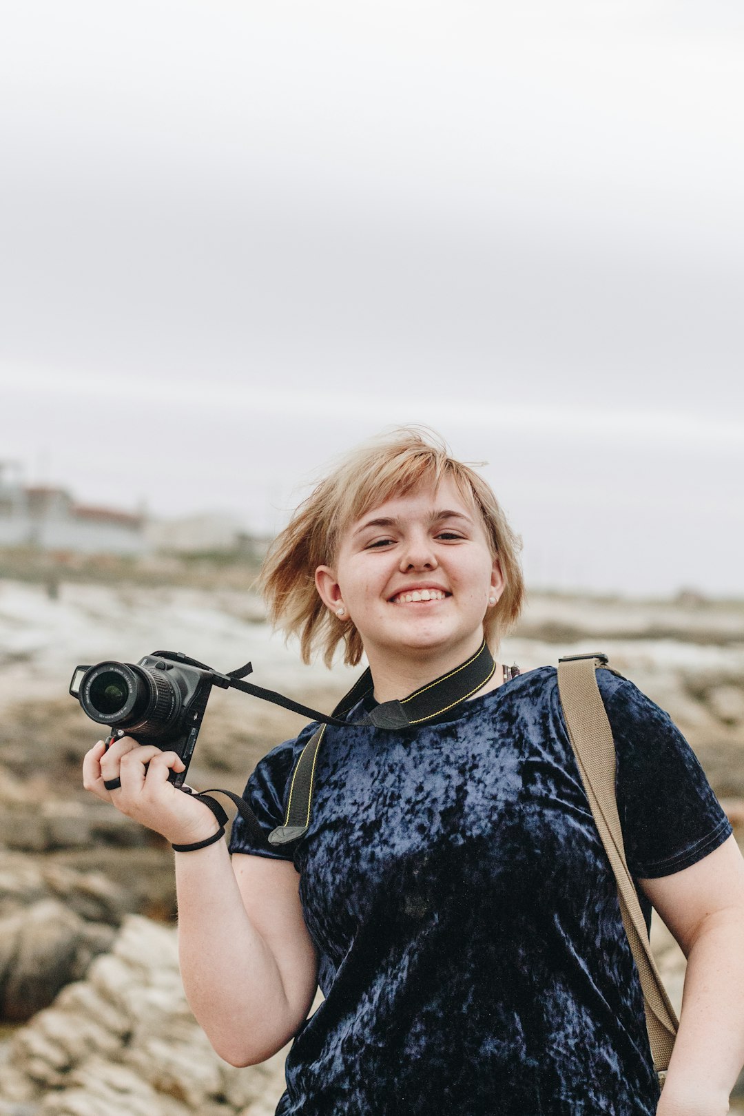 smiling woman holding camera