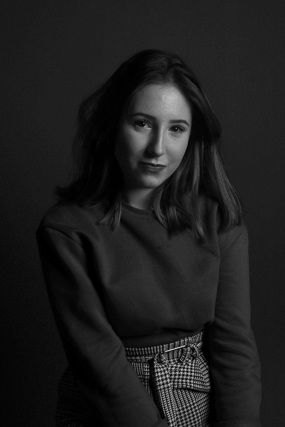 grayscale photography of woman wearing long-sleeved shirt