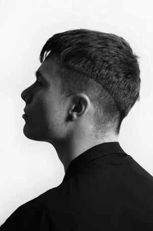 a black and white photo of a young man