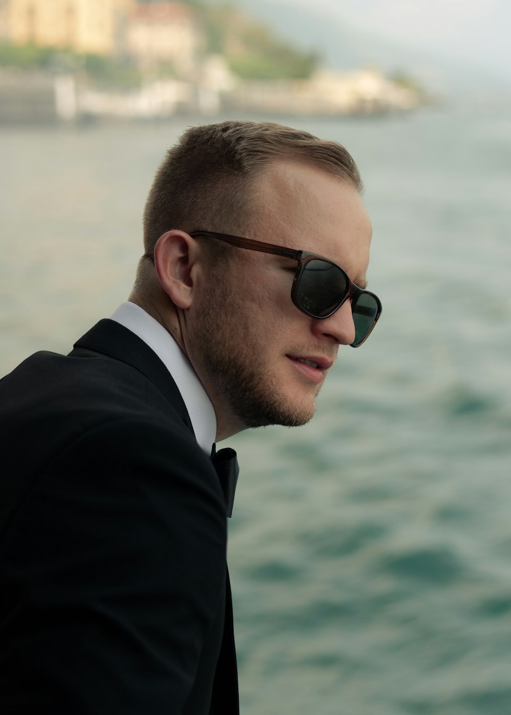 man wearing black tuxedo and black wayfarer sunglasses