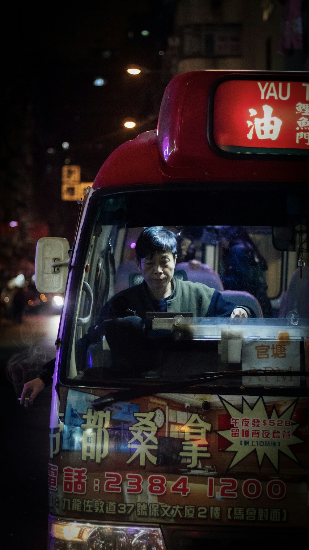 man sitting inside bus at night