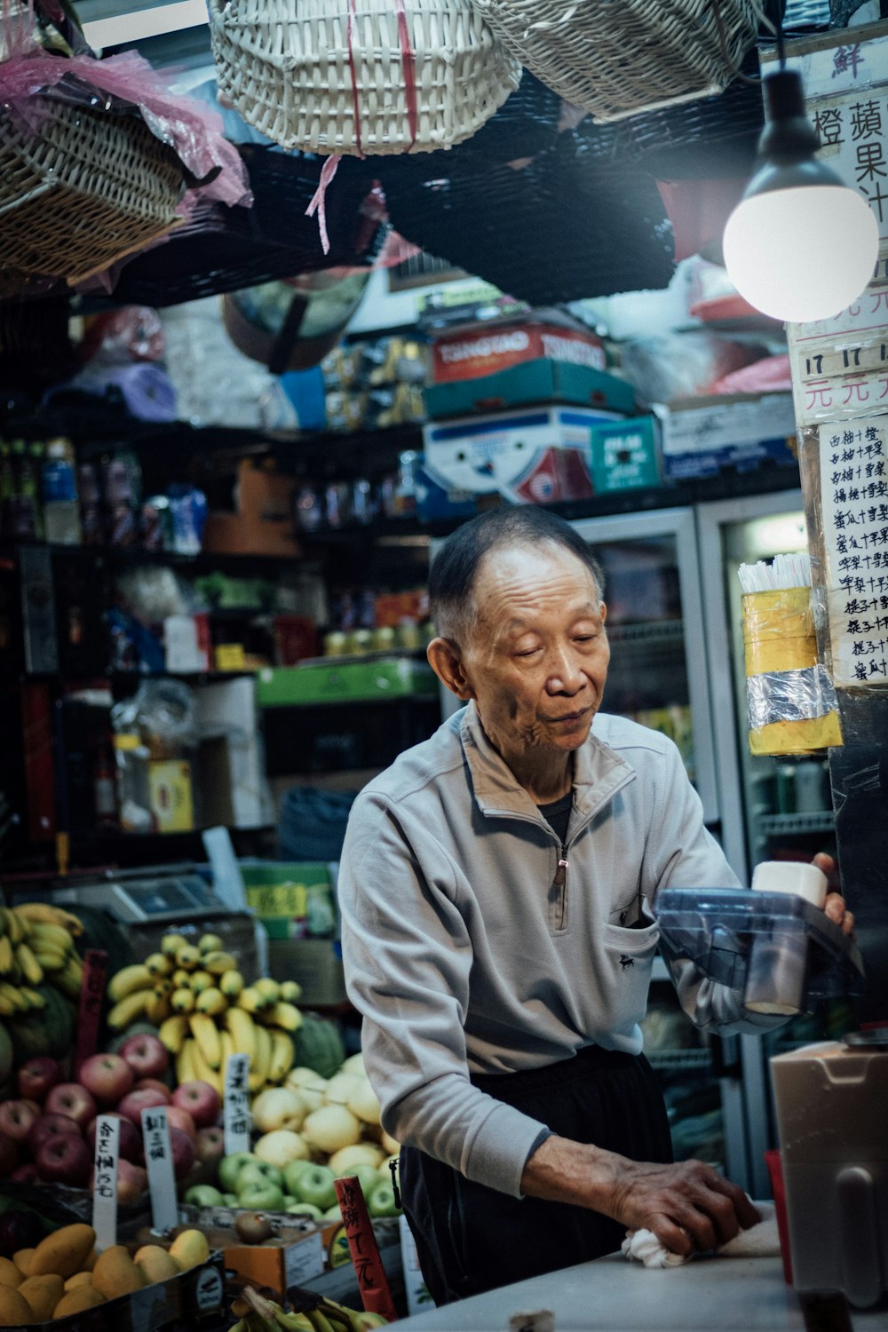 man standing inside fruit store