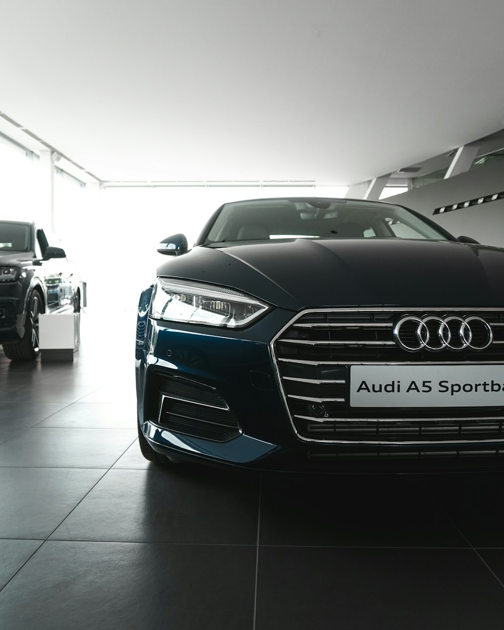 blue Audi A5 parked inside garage