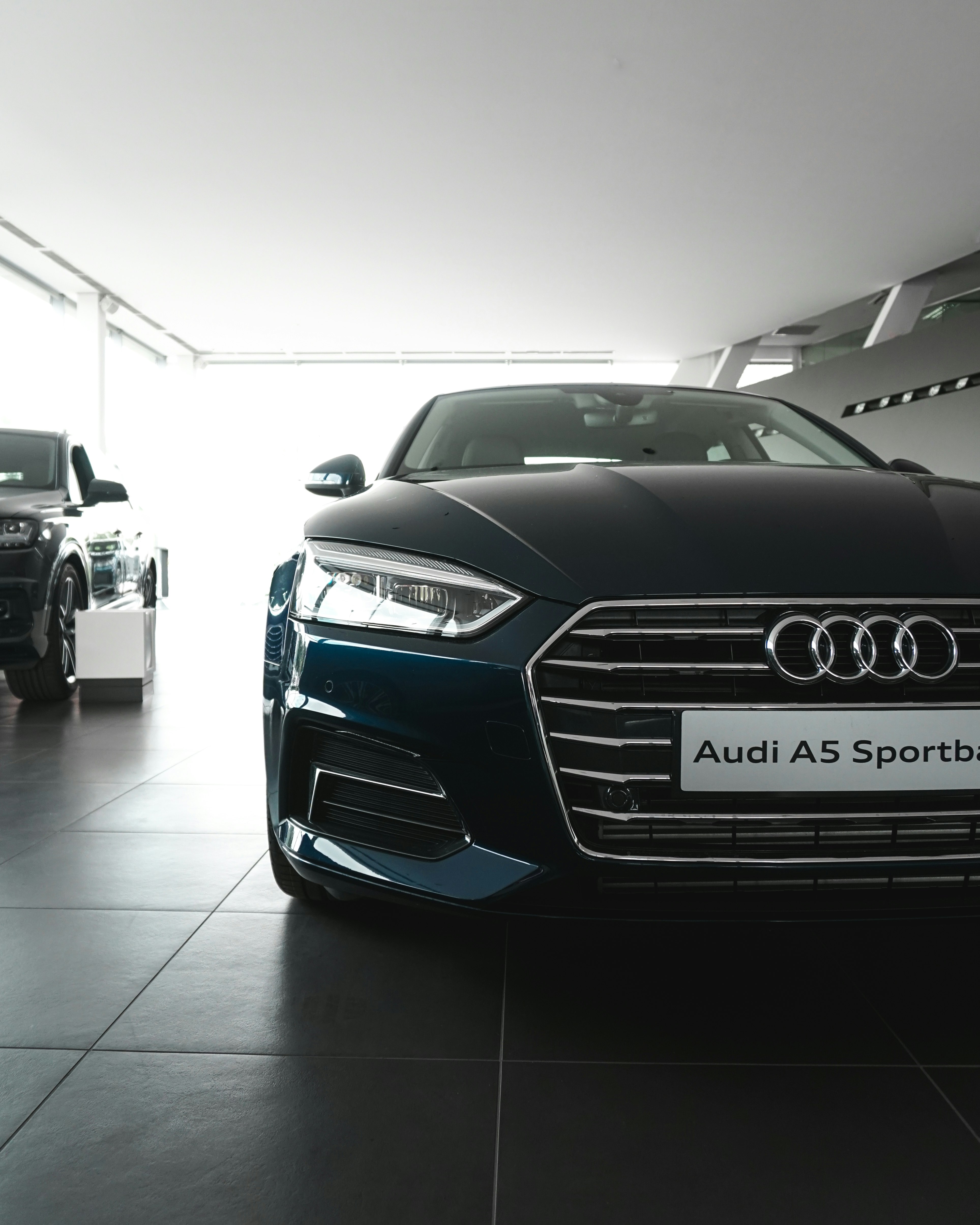 blue Audi A5 parked inside garage