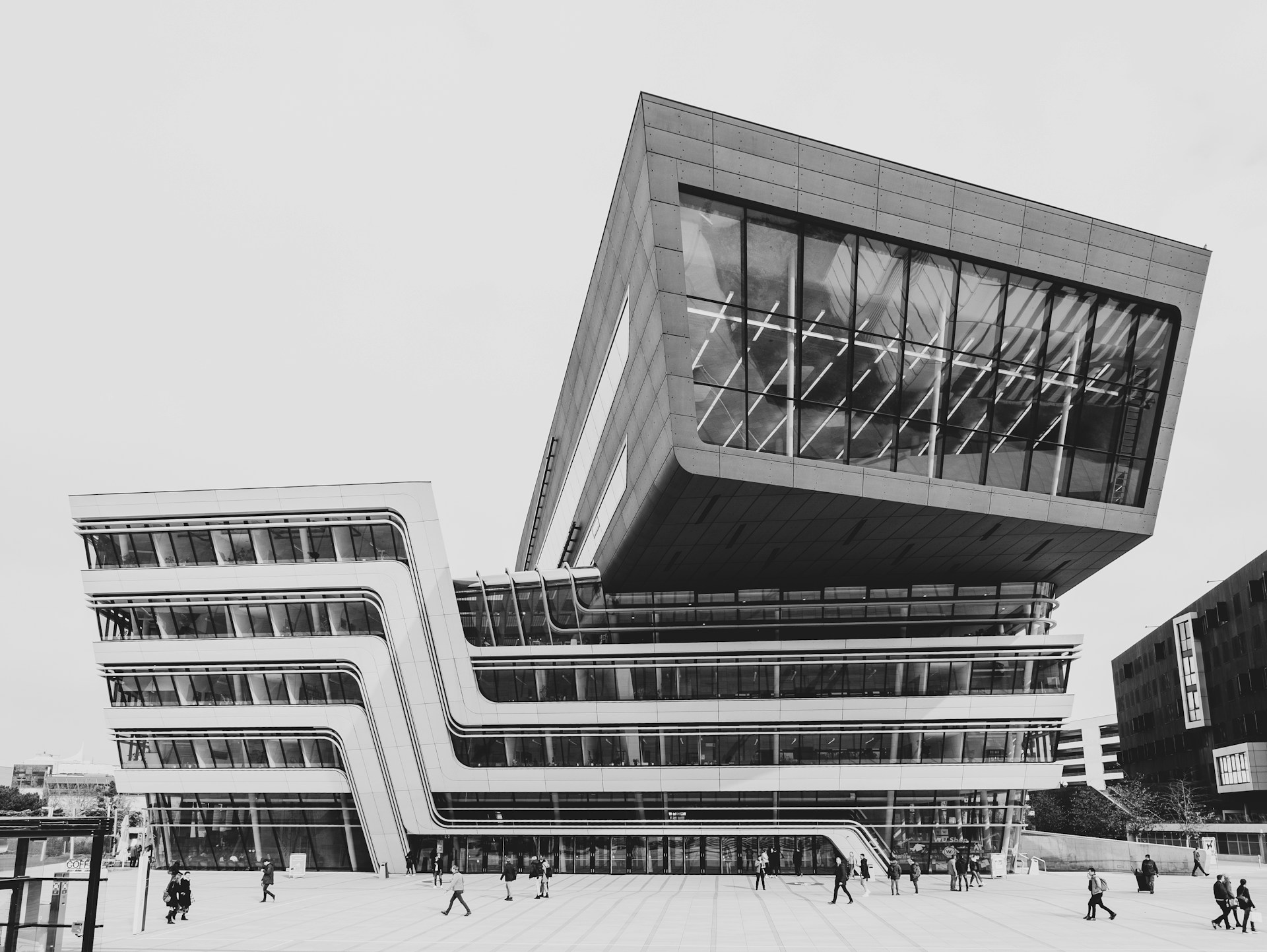 grayscale photo of people in front of building