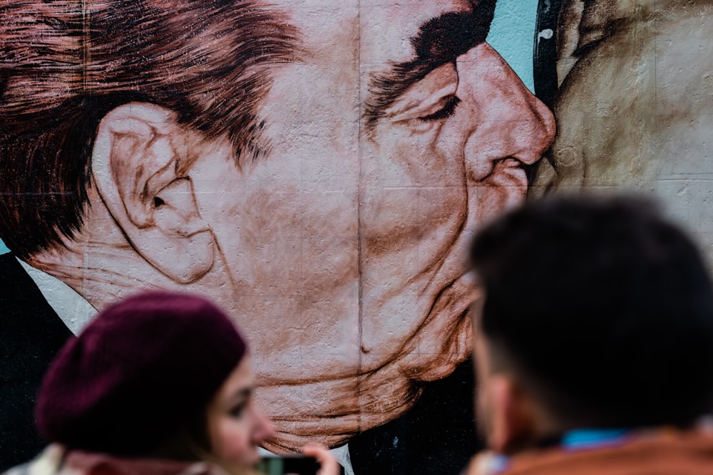 a large painting of a man's face on the side of a building