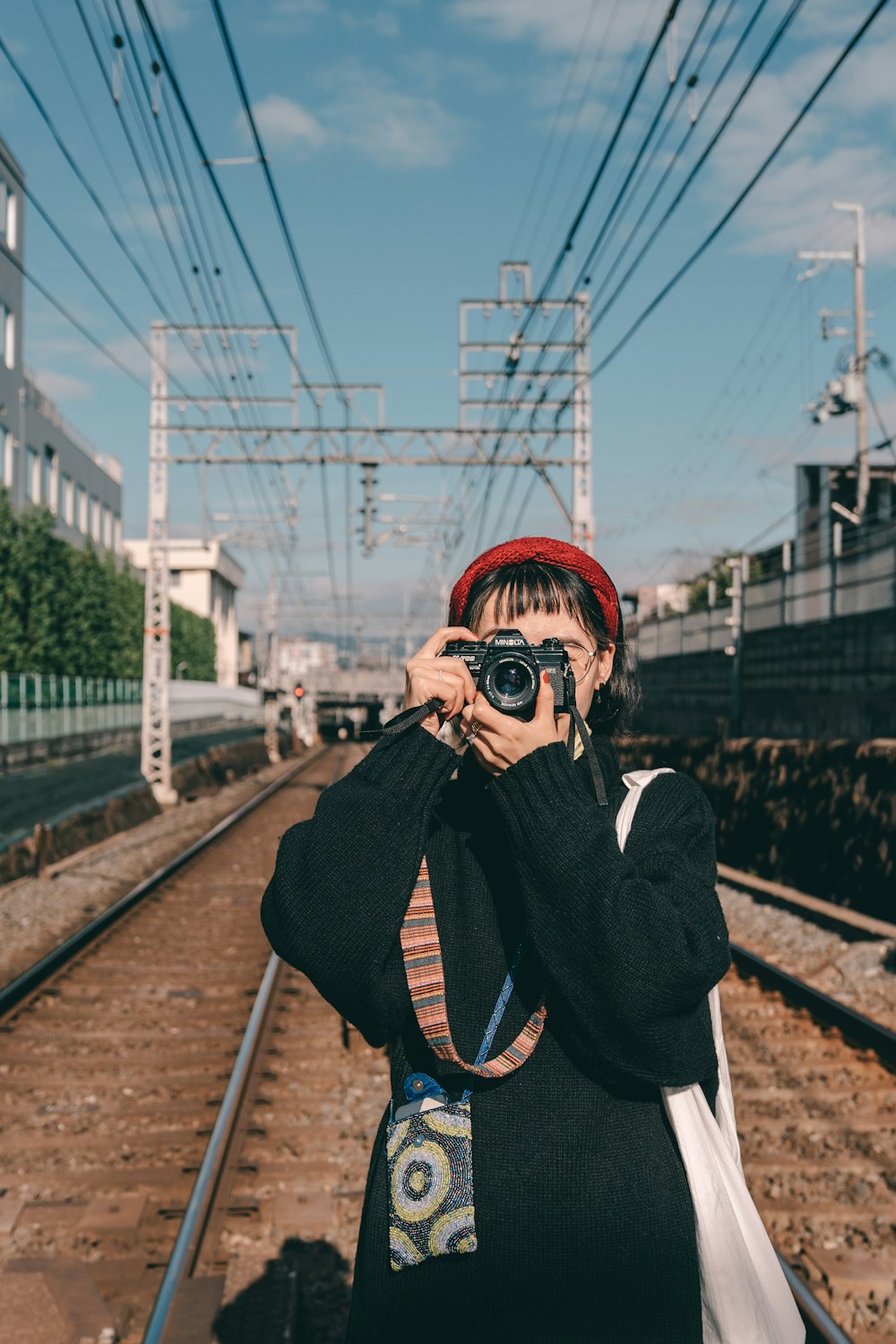 shallow focus photo of woman using black point-and-shoot camera