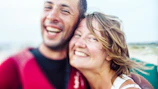 Young couples smiling and sharing a moment of joy together.