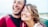 Close-up of smiling faces from different ethnic backgrounds showing genuine happiness together.