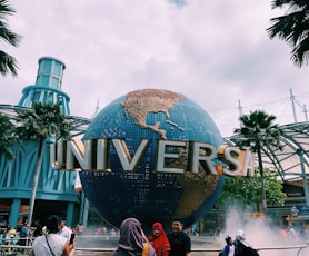 people taking photos in front of Universal globe