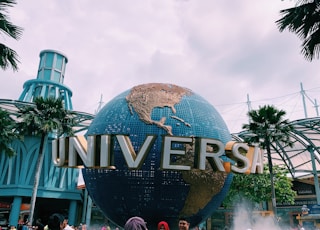 people taking photos in front of Universal globe