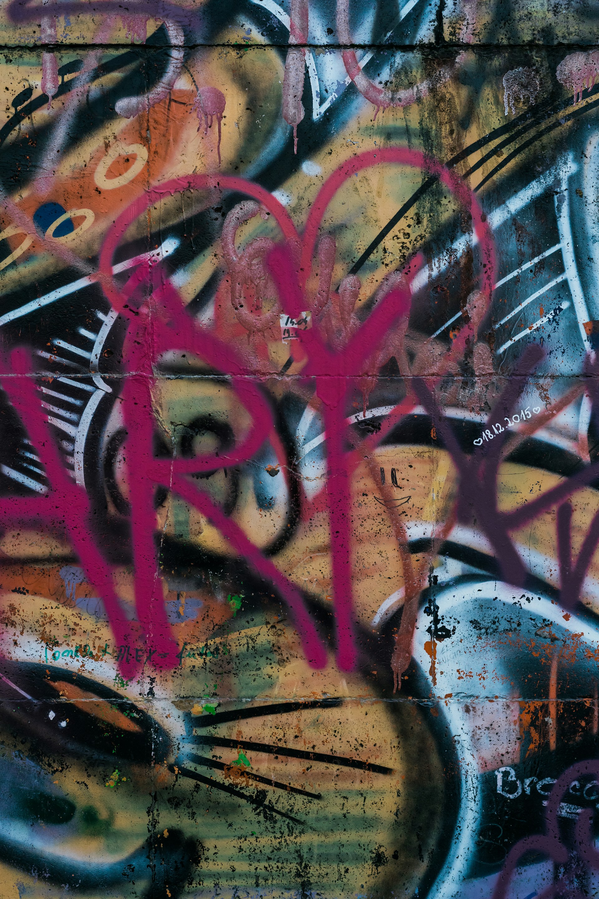 Close-up of detailed graffiti strokes and bright paint splashes on the mural, capturing the energy of youth expression.