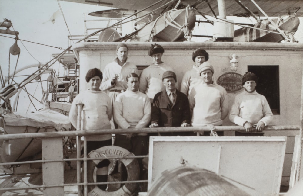 grayscale photo of people riding boat