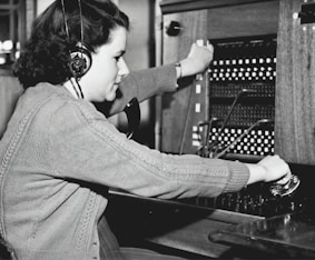 grayscale photo of woman using headphones