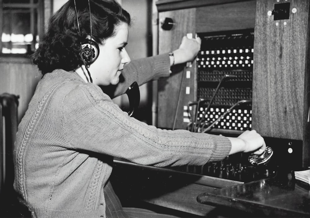grayscale photo of woman using headphones