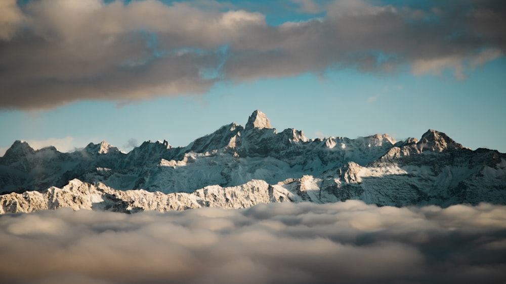 snow capped mountain under cloudy sky during daytime