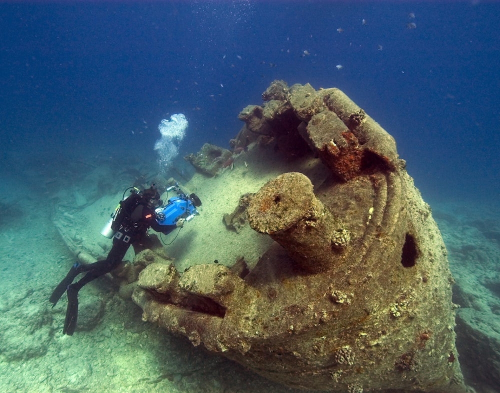 person scuba driving underwater