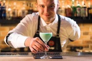 green liquid in clear footed wine glass