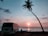 A comfortable travel van parked near a scenic temple entrance during sunset.