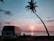 A comfortable travel van parked near a scenic temple entrance during sunset.