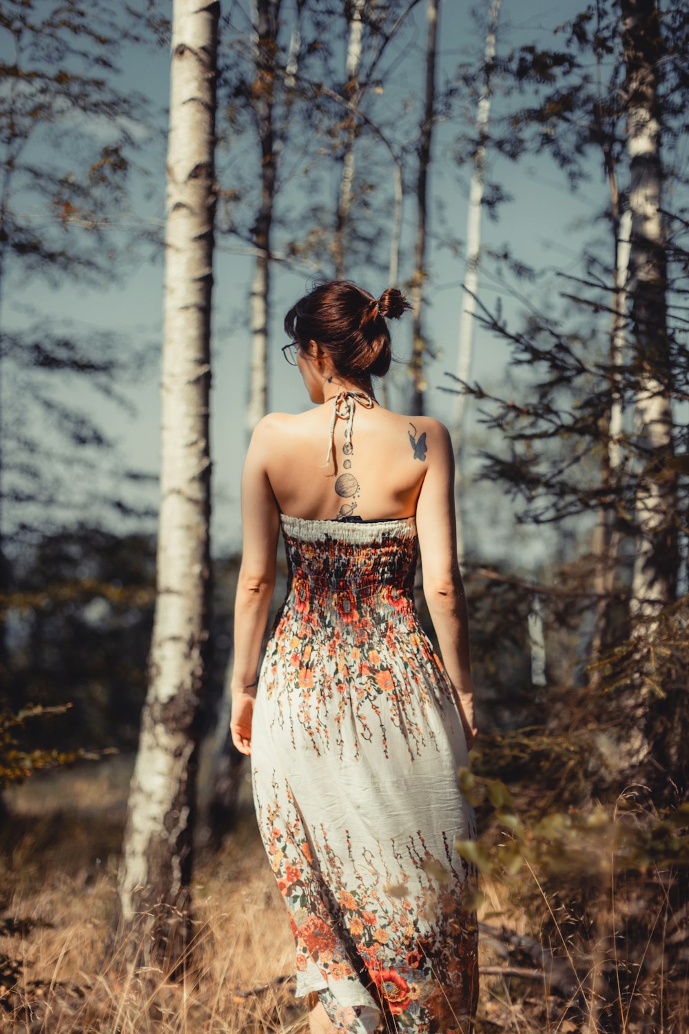 woman standing beside trees during daytime