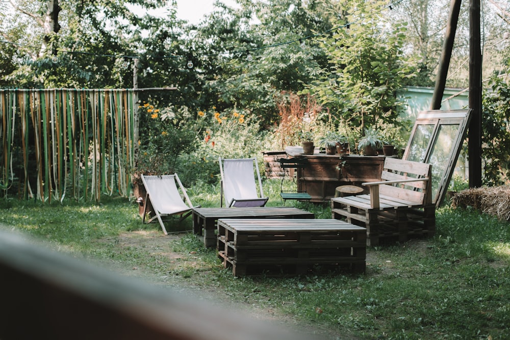 brown wooden bench near folding chairs and wood pallet