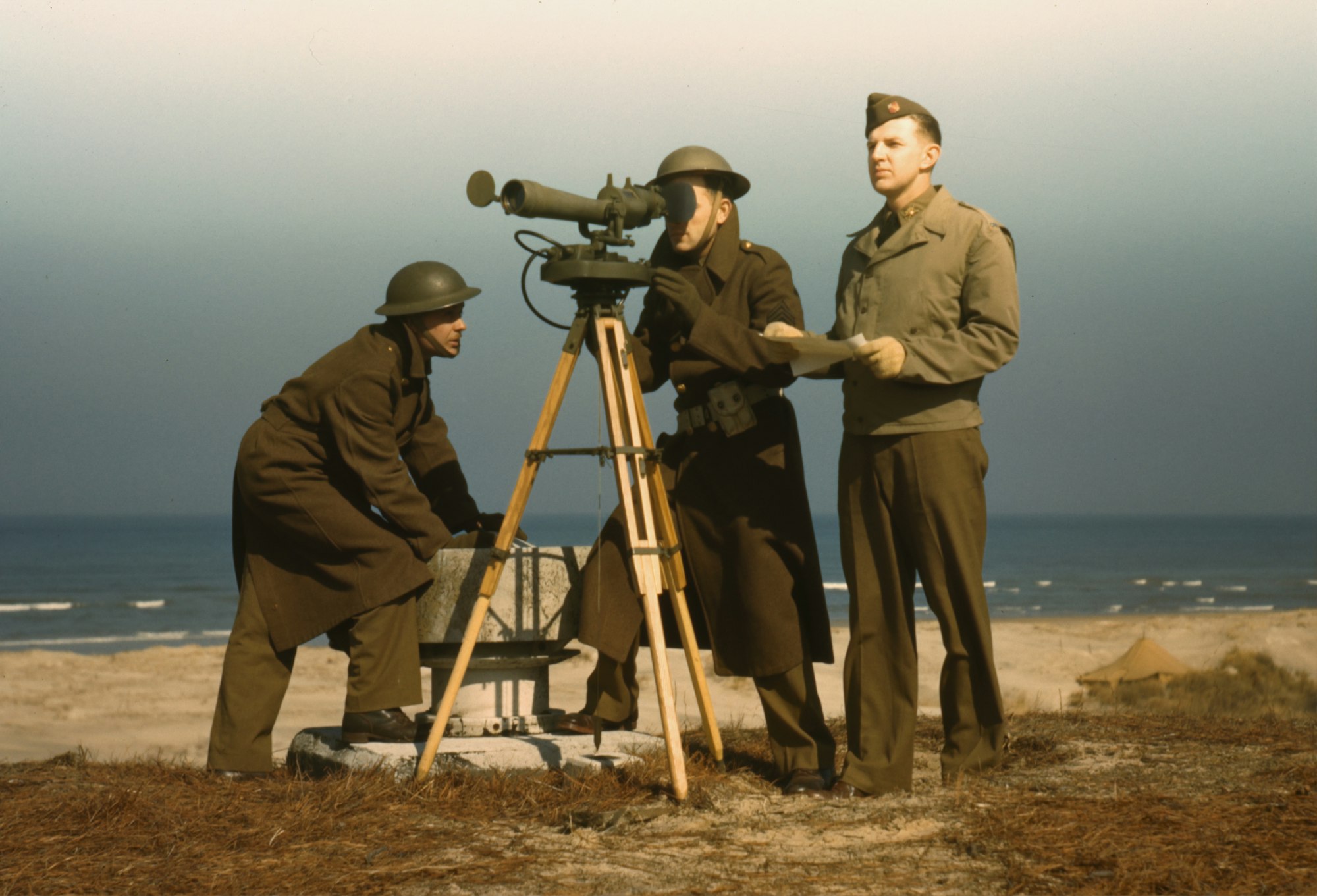 Men of Fort Story operate an azimuth instrument, to measure the angle of splash in sea-target practice, Fort Story, Va. Color transparency by Alfred T. Palmer, 1942. From the Farm Security Administration/Office of War Information Collection. Library of Congress Prints & Photographs Division.

https://www.loc.gov/resource/fsac.1a35088/

