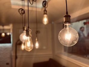 Brightwire electrician installing energy-efficient lighting in a cozy living room