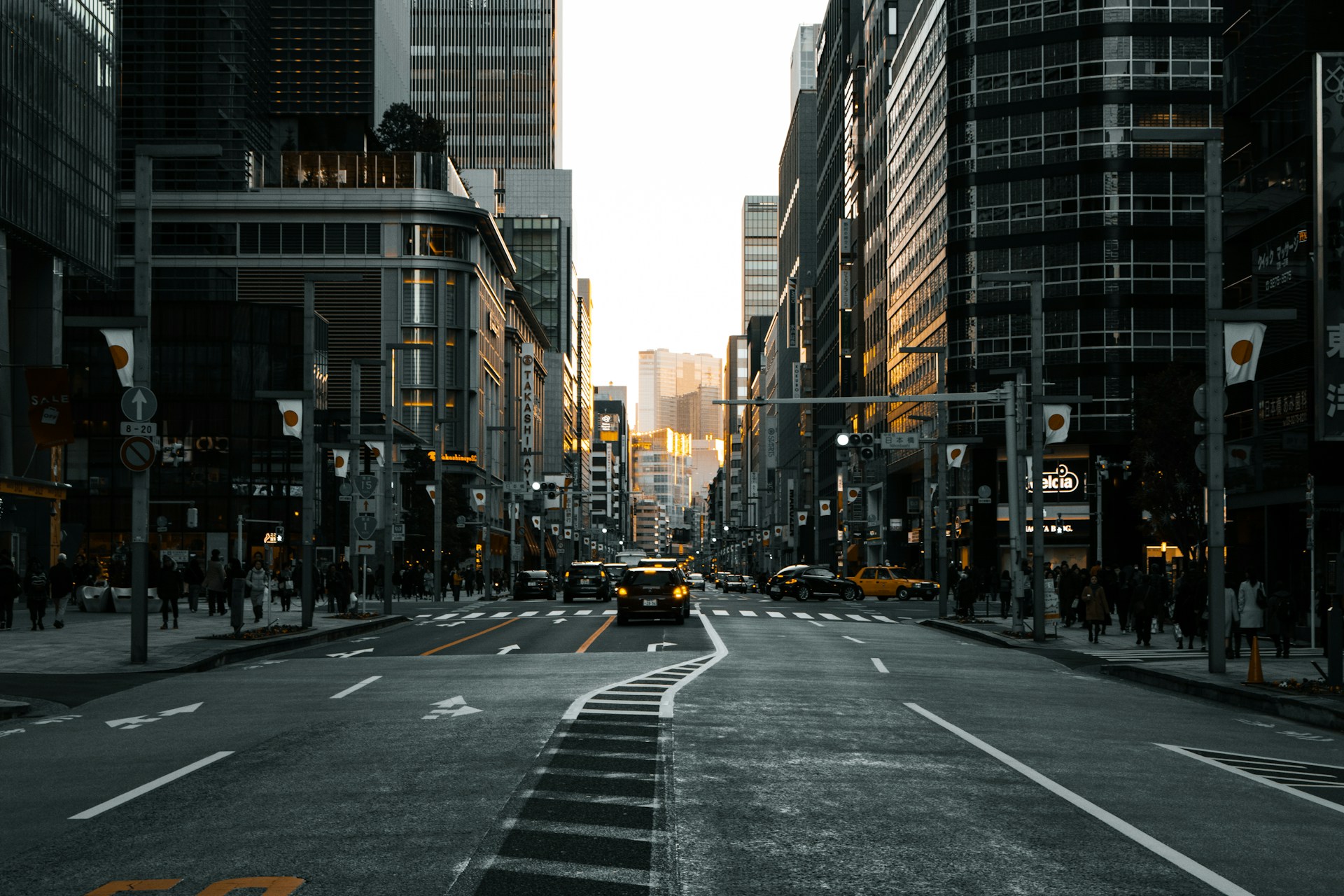 black vehicle on road between buildings during daytime
