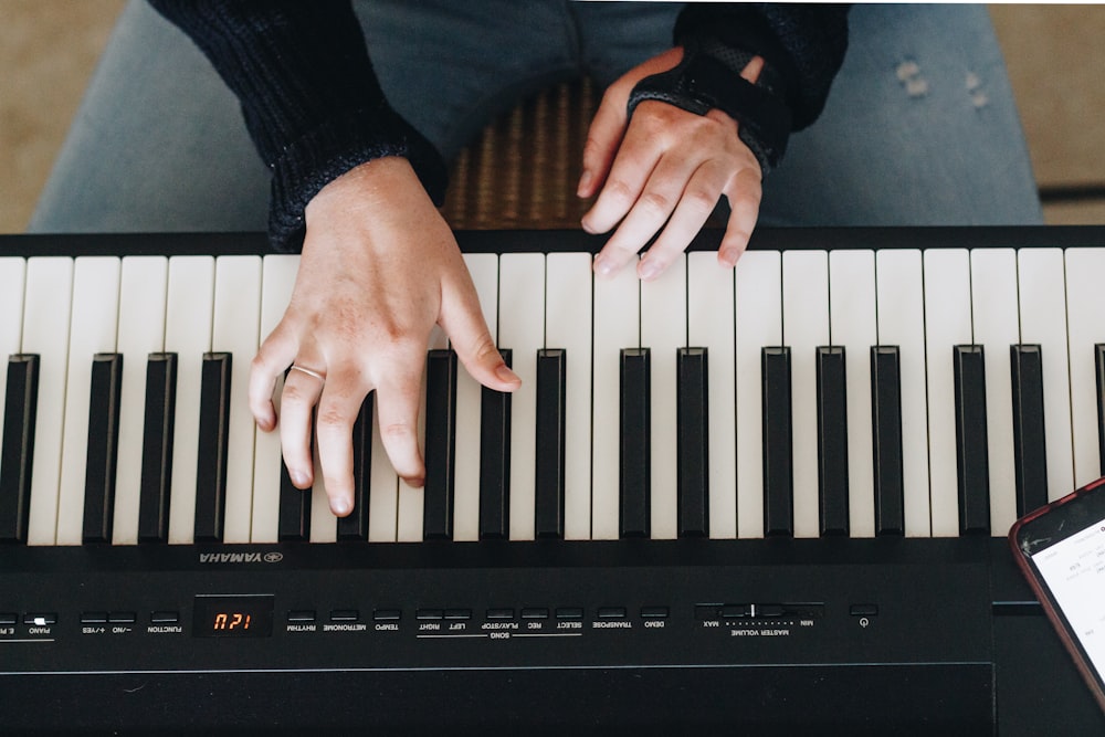 person playing electronic keyboard