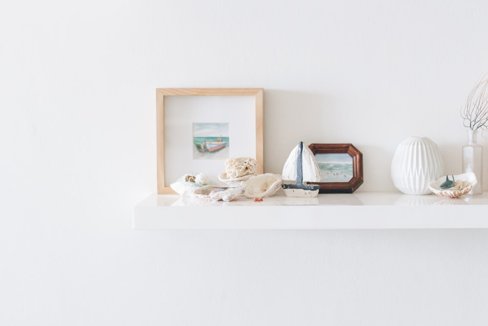 brown photo frame beside wall