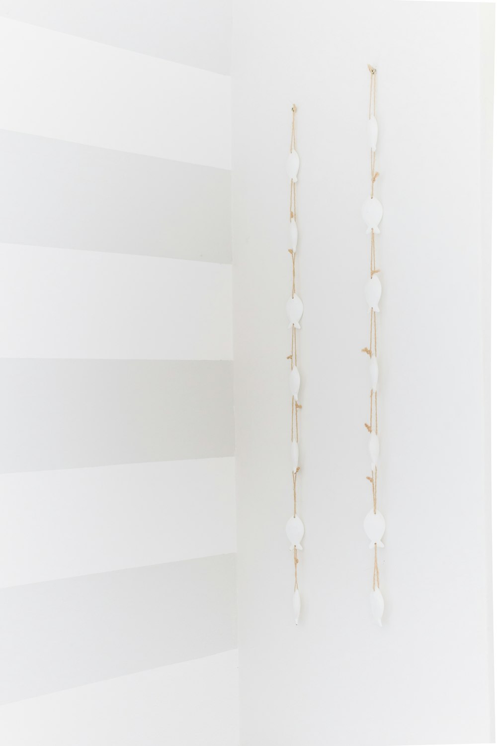 white hooks on white wall