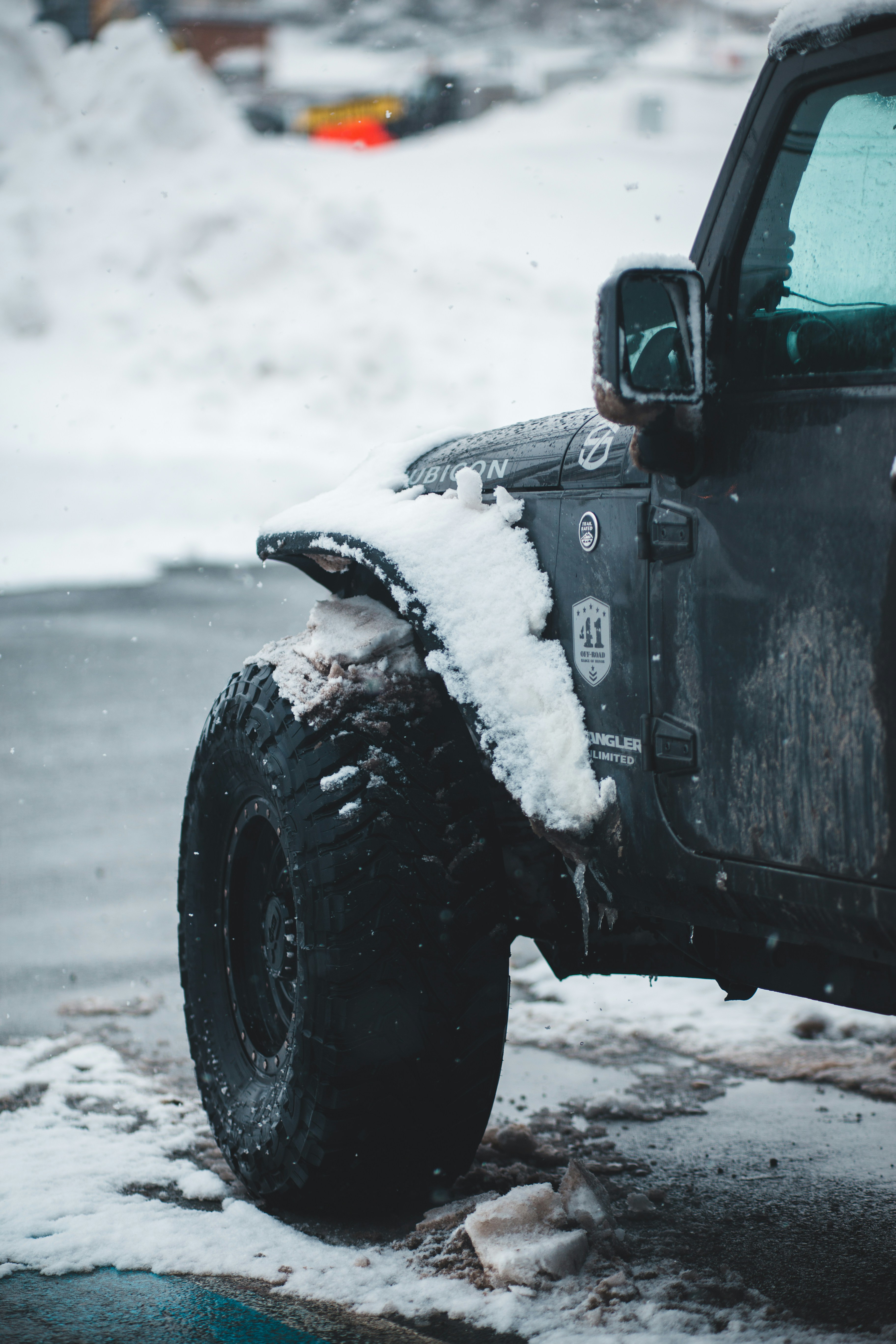snow covered parked black SUV