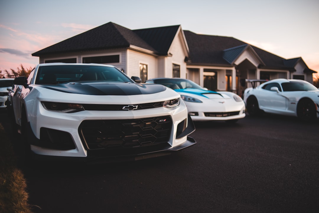 white coupes parked in front of house