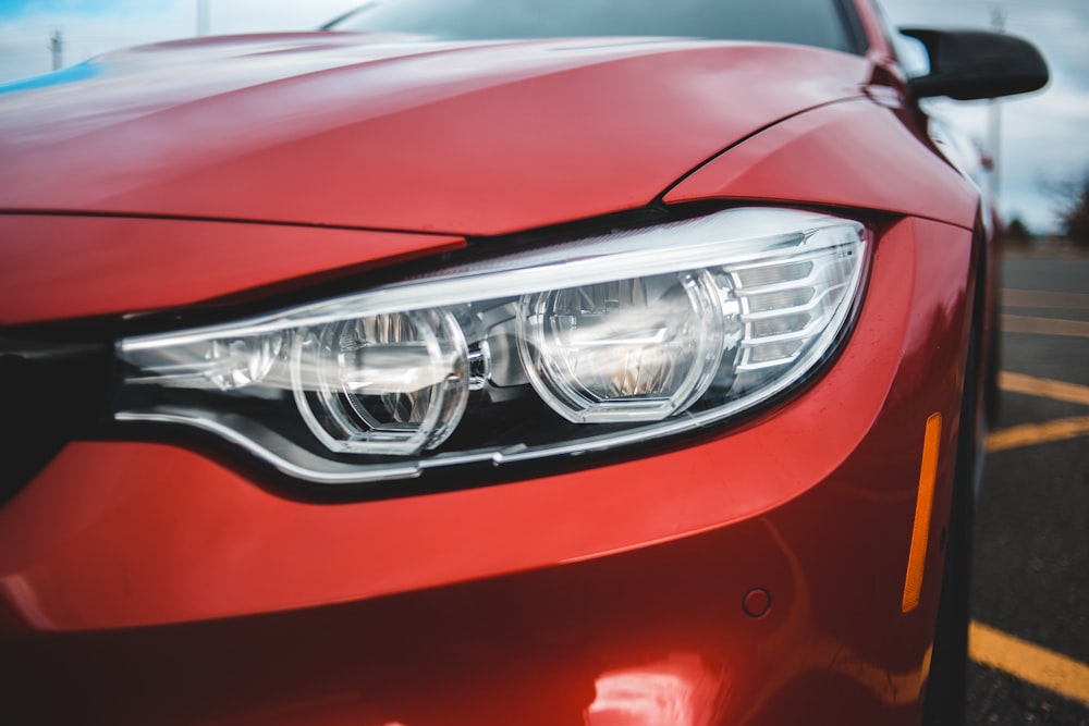 selective focus photography of parked red BMW vehicle