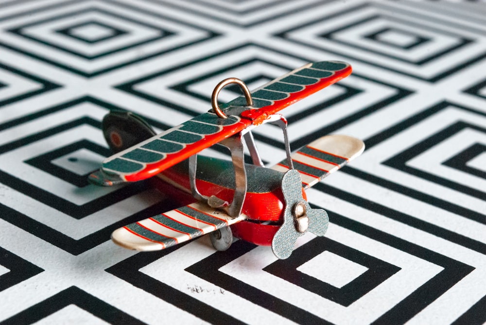 multicolored biplane miniature on white surface