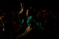 Binoy Cherian in costume, delivering a powerful dramatic scene on stage.