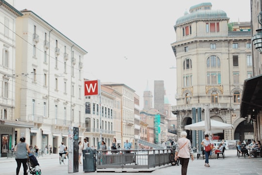 people walking on street in front of buildings in Bologna Italy