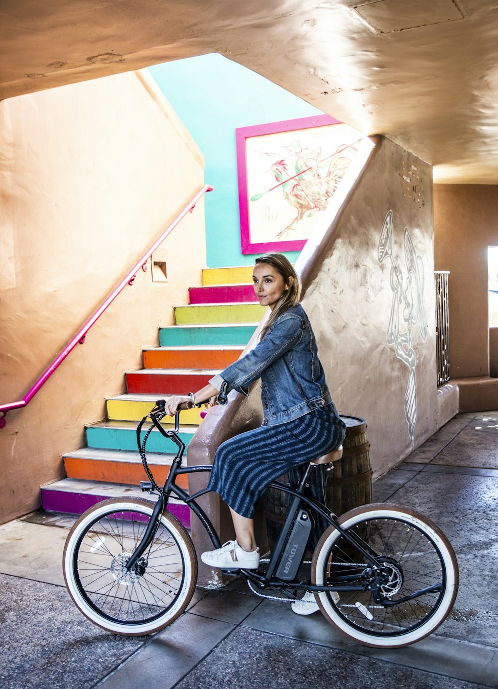 woman wearing blue denim jacket and shorts riding on bike