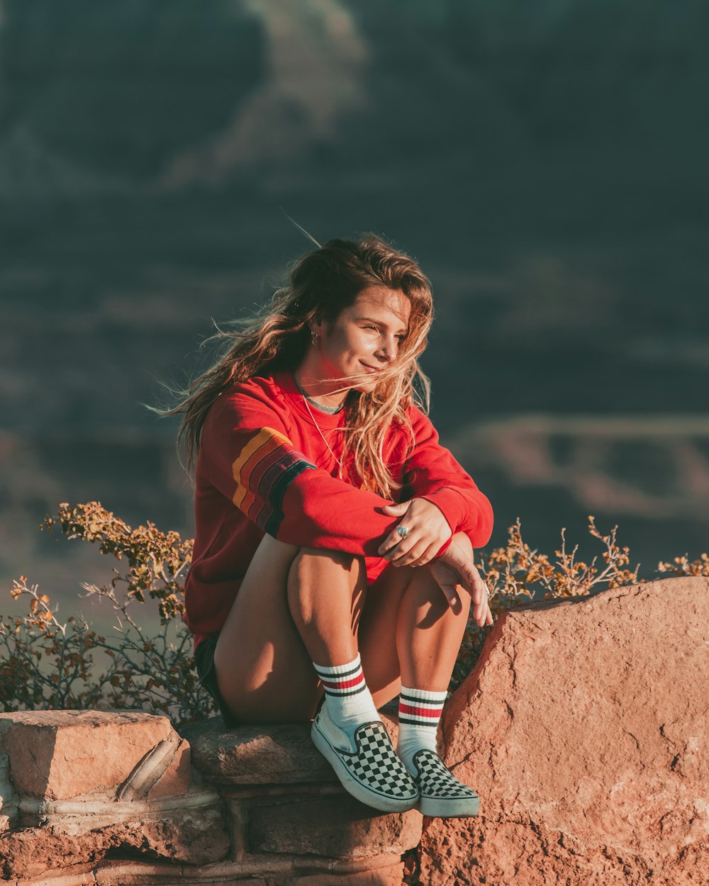 woman sitting on rock formation