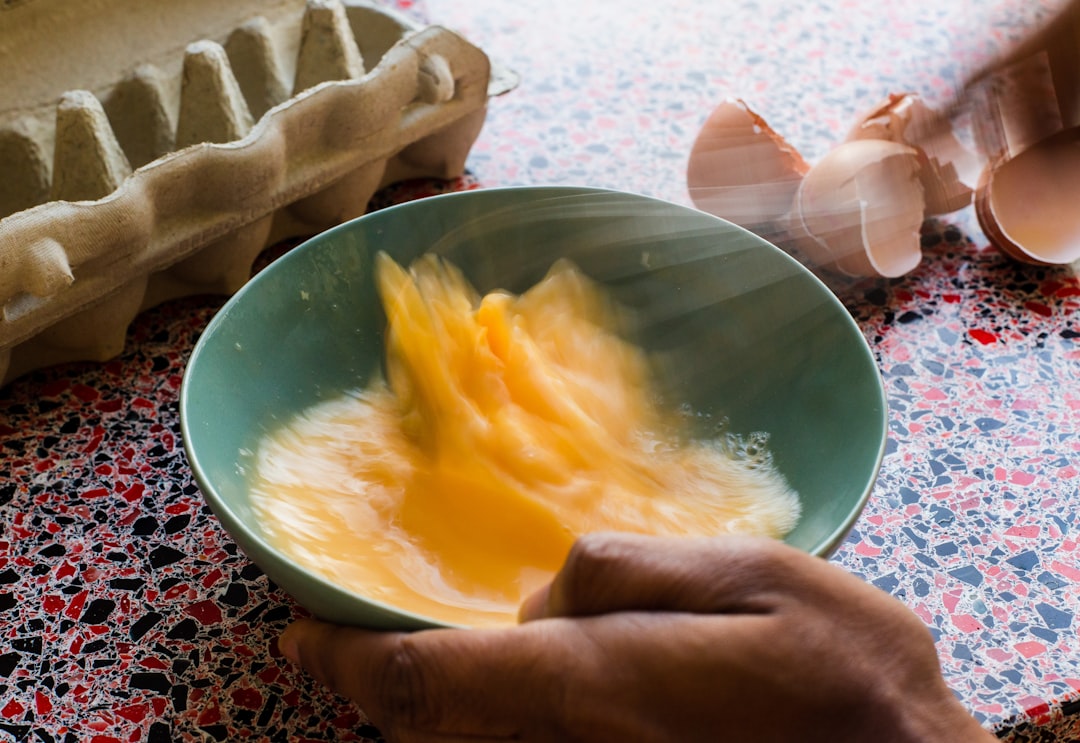 beaten egg in round bowl