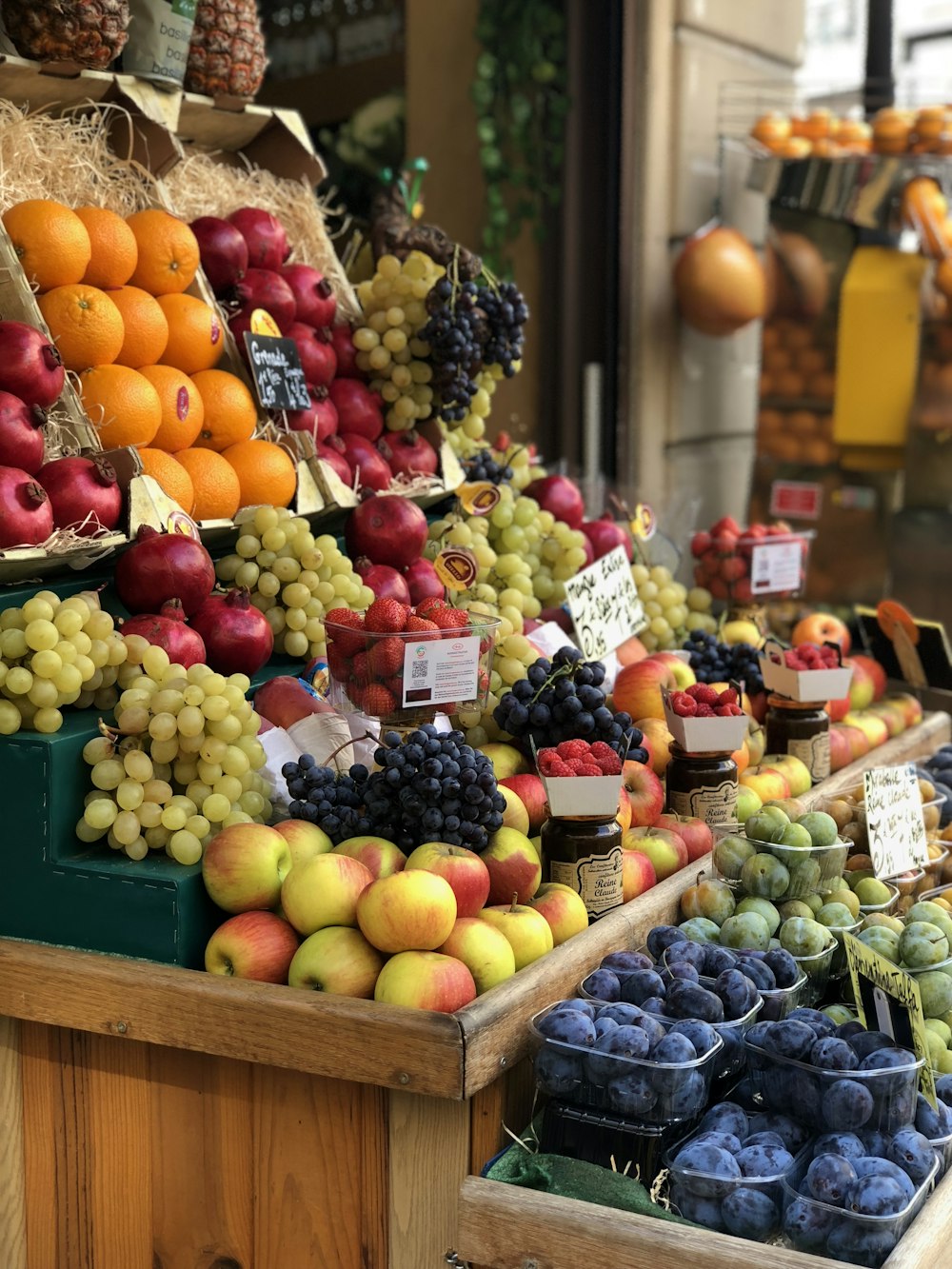 a fruit stand with a variety of fruits on display