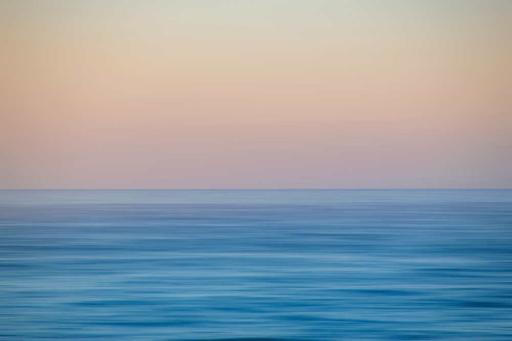 a large body of water with a boat in the distance