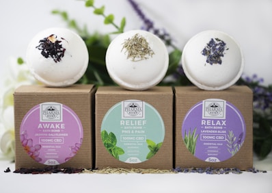 three assorted-label bath bombs with boxes