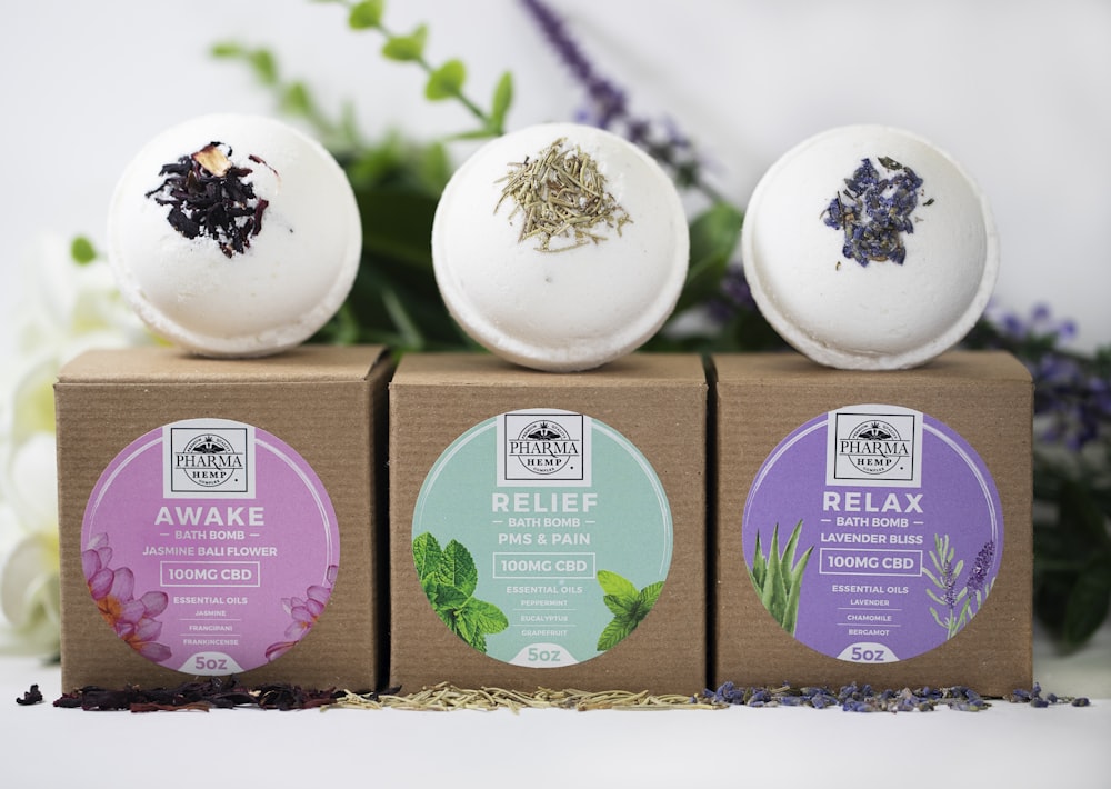 three assorted-label bath bombs with boxes